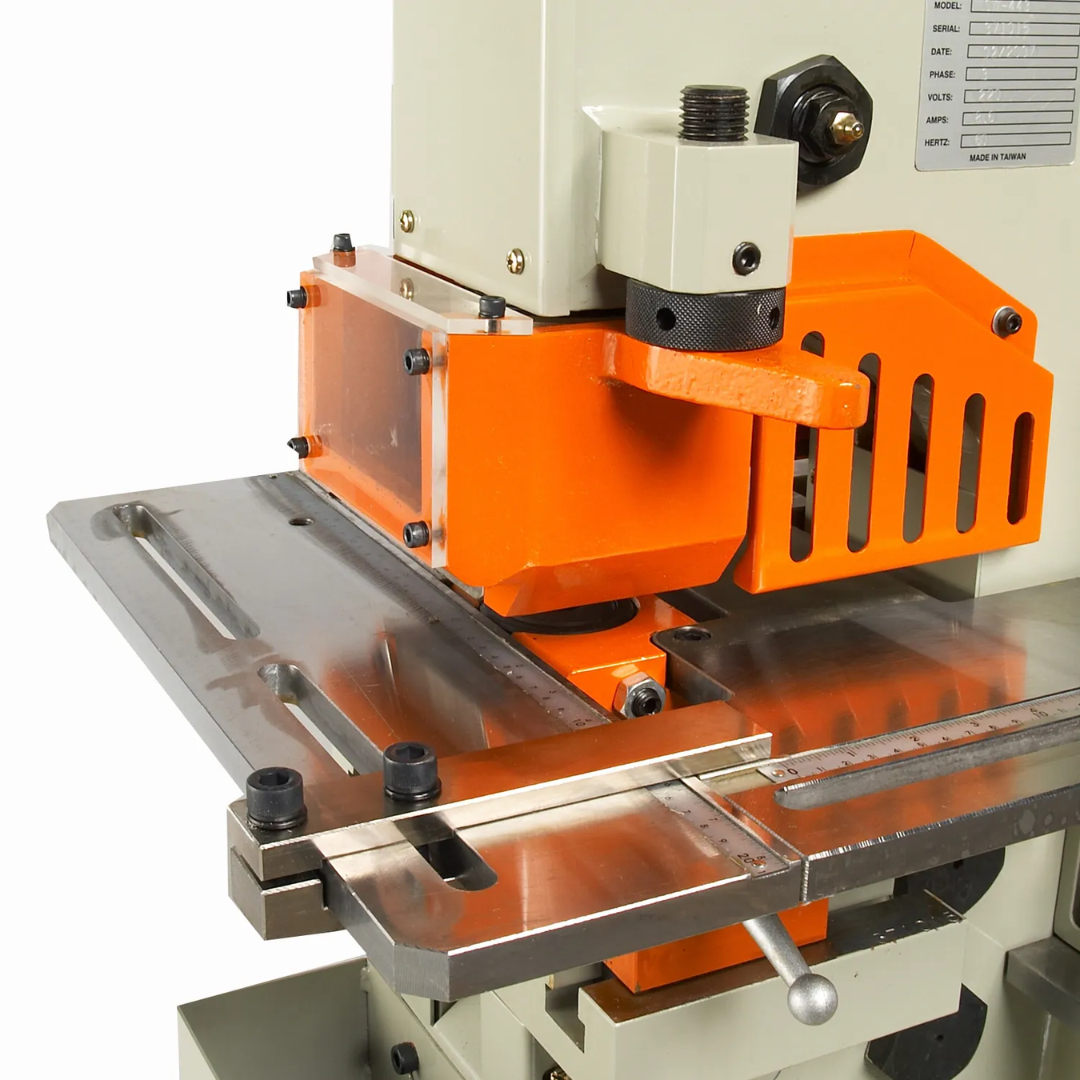 Baileigh Hydraulic Iron Worker SW-621 1007809 close-up of the punching worktable with adjustable fence, hydraulic ram, and precision tooling for industrial metalworking operations.