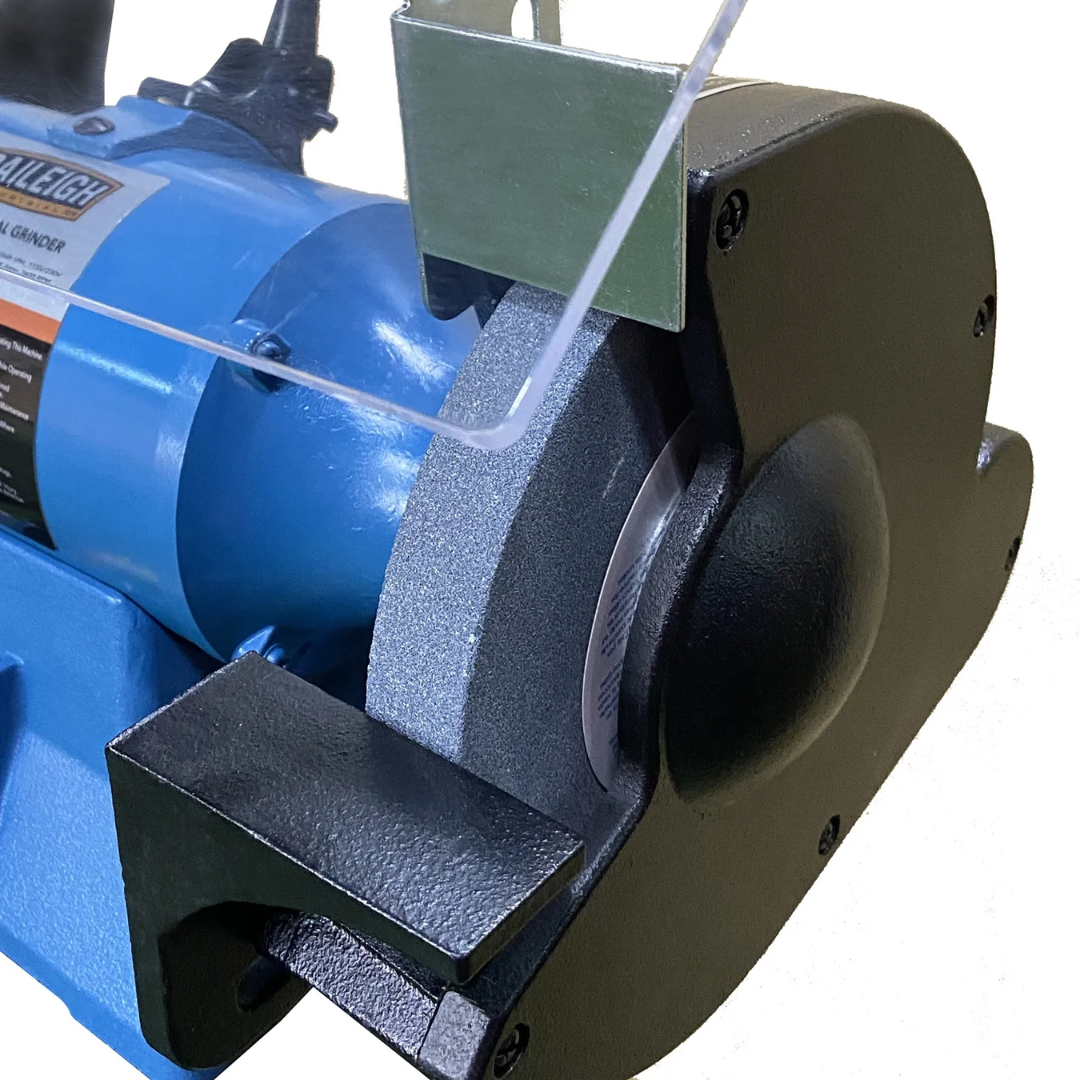 Close-up of Baileigh 8" Bench Grinder - (IGB-8) 1227895 grinding wheel assembly with protective guards designed for safe and accurate metal grinding operations.