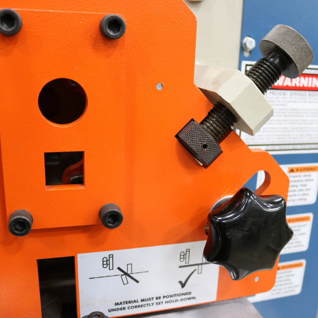 Close-up of the Baileigh 44-Ton 4-Station Hydraulic Ironworker, 220V 3Ph (SW-443) 1007757 adjustable work stop and material guide for precise metal fabrication and production accuracy.