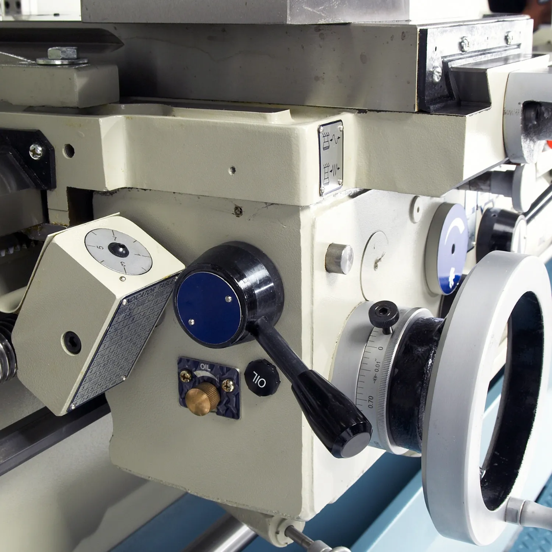 Close-up of the Baileigh Precision Metal Lathe PL-2080 1006176 carriage and apron controls providing smooth, precise feed adjustment for turning and threading operations.