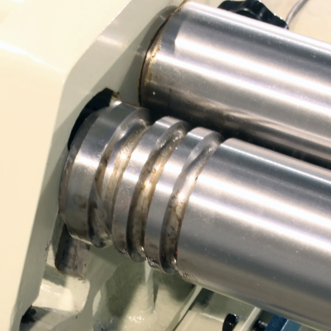 Close-up of the forming rollers on the Baileigh 50-Inch Electric Slip Roll, Open Stand (SR-5016E) 1007336 showing precision-machined rolls designed for accurate sheet metal rolling and cylinder formation.