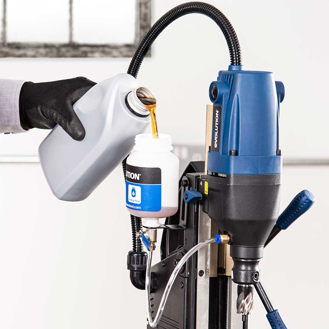 Evolution Power Tools 1-1/8 in. Magnetic Drill With Carry Case S28MAG being positioned on structural steel for portable on-site drilling, combining strong magnetic holding power with compact industrial performance.