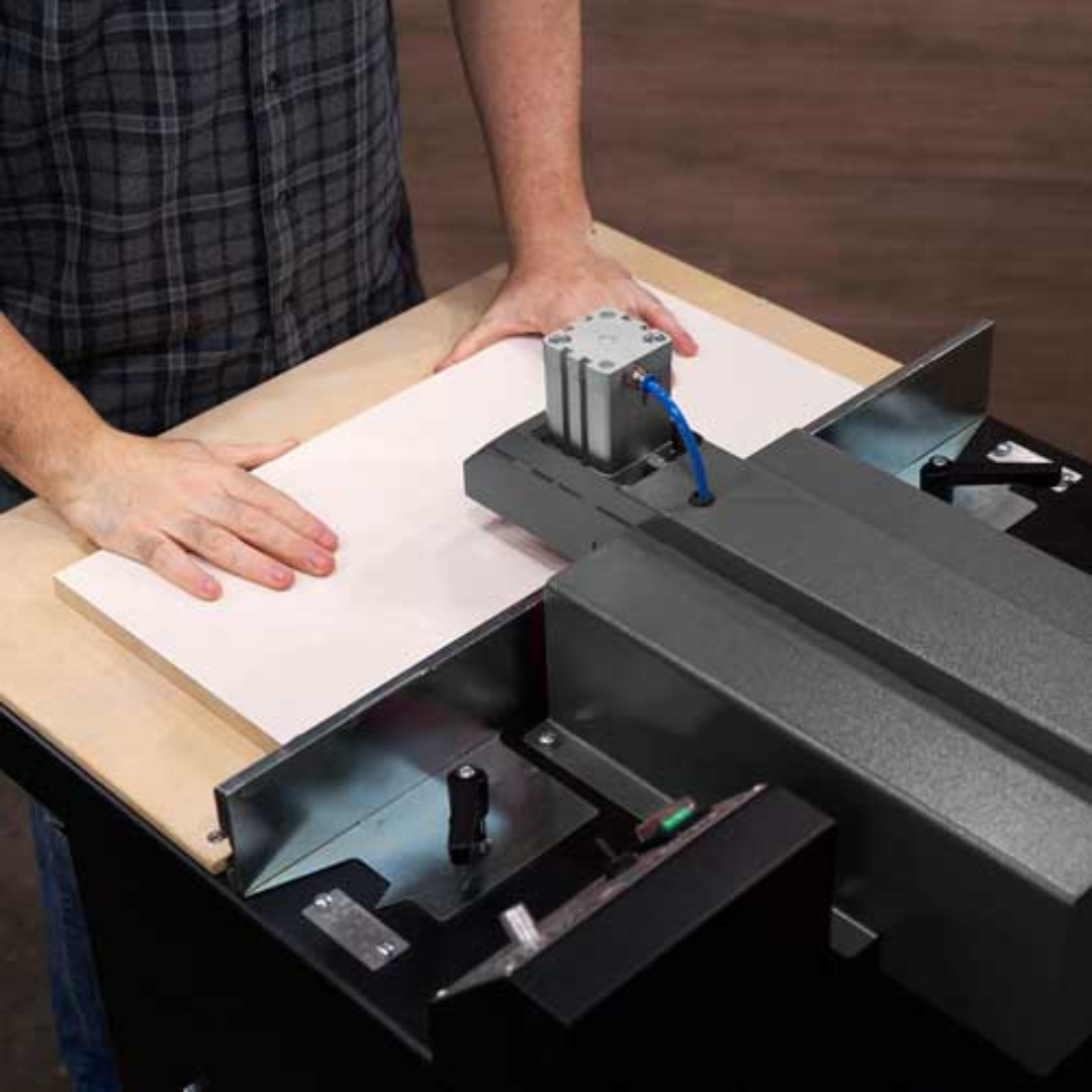Hands positioning wood on Maksiwa PHM.30 Pocket Hole Machine fence system