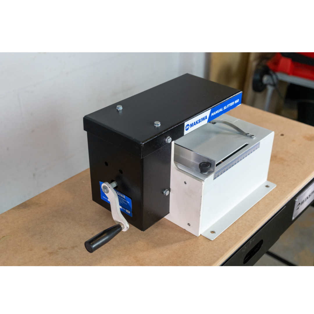 Maksiwa F.160 manual slitter mounted on workbench, demonstrating manual slitting operation in a workshop setting