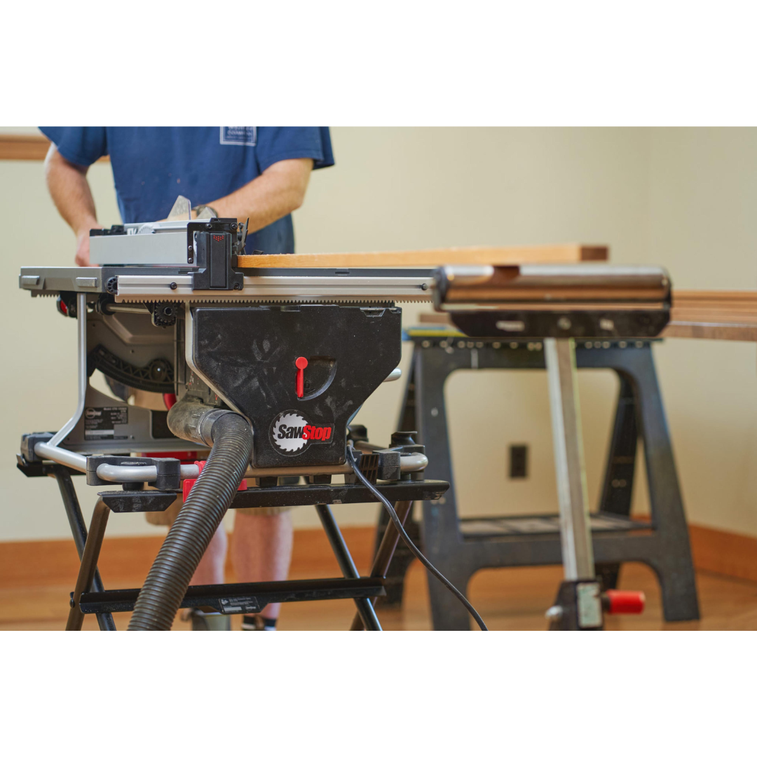 Operator using the SawStop Compact Table Saw on a workbench for accurate cutting and efficient material handling.