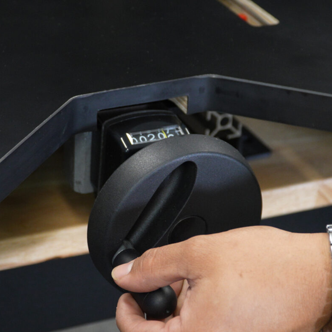 Operator adjusting the Maksiwa HBM-1000 control knob for machine operation settings