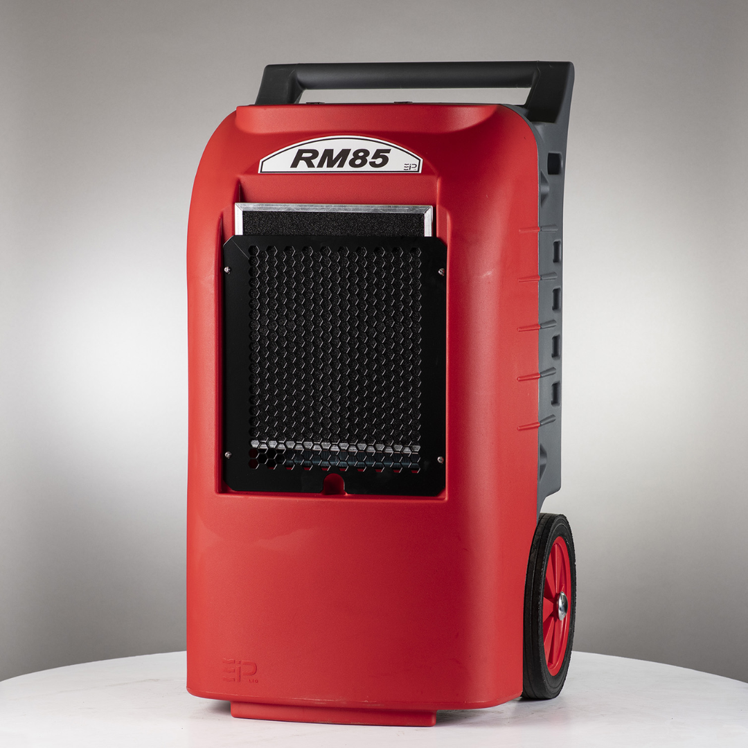 Portable industrial Ebac RM85/RM85-H Dehumidifier with rugged red housing, front air intake grille, and heavy-duty transport wheels for water damage restoration