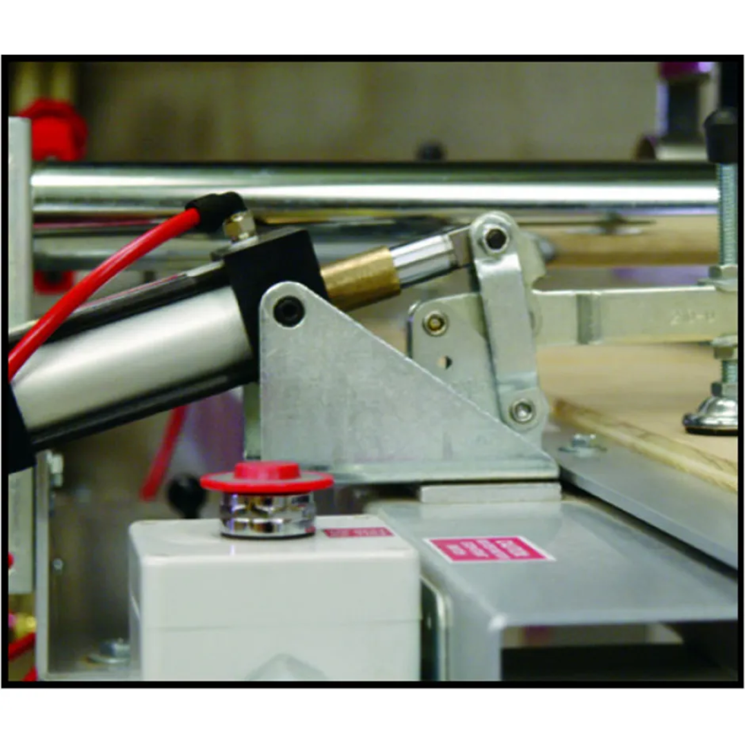 Safety Speed Air Clamps for 3400 Vertical Router and TR2 Table Router mounted on machine frame showing pneumatic cylinder and clamping mechanism for secure material hold-down.