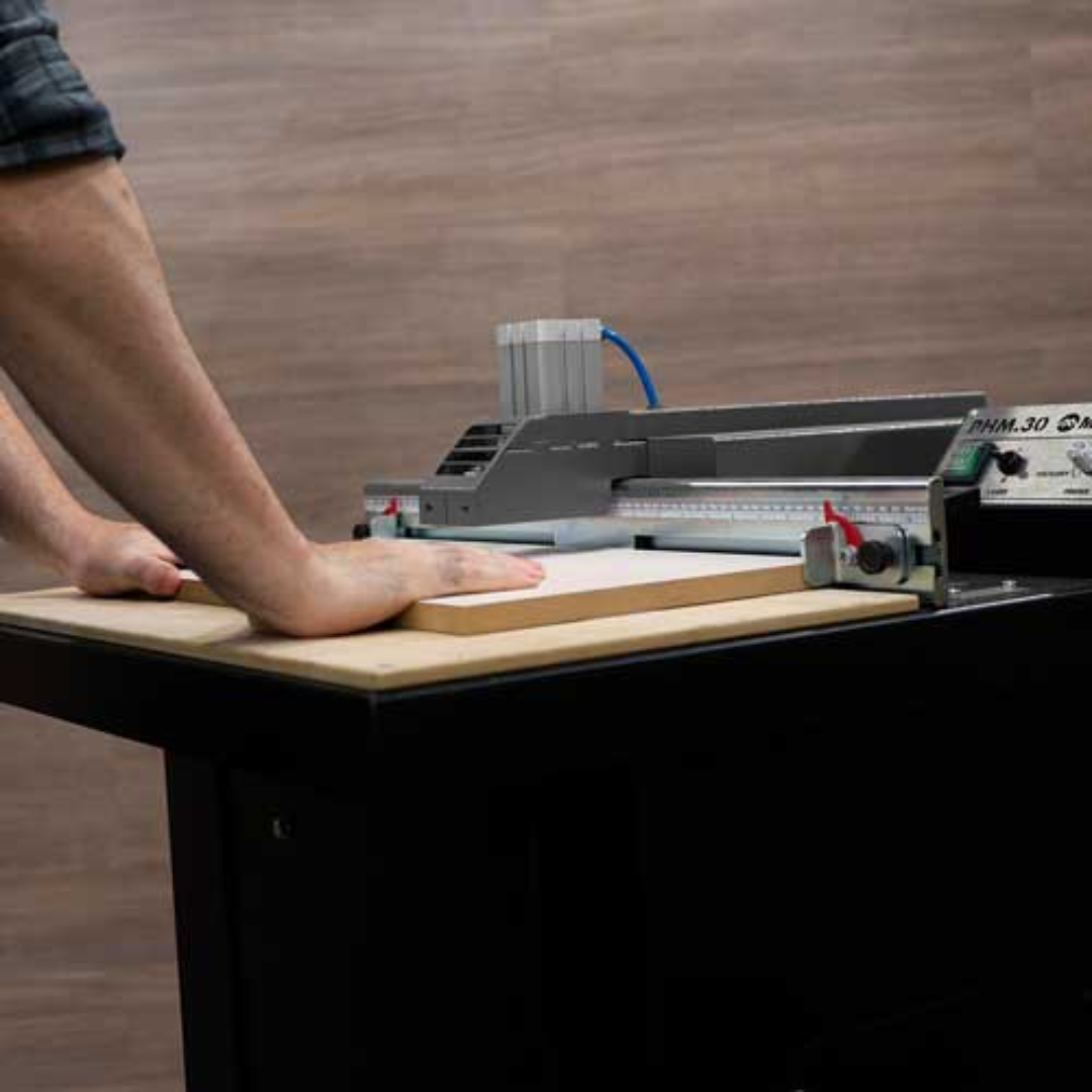 Side view of Maksiwa PHM.30 Pocket Hole Machine with material resting on table