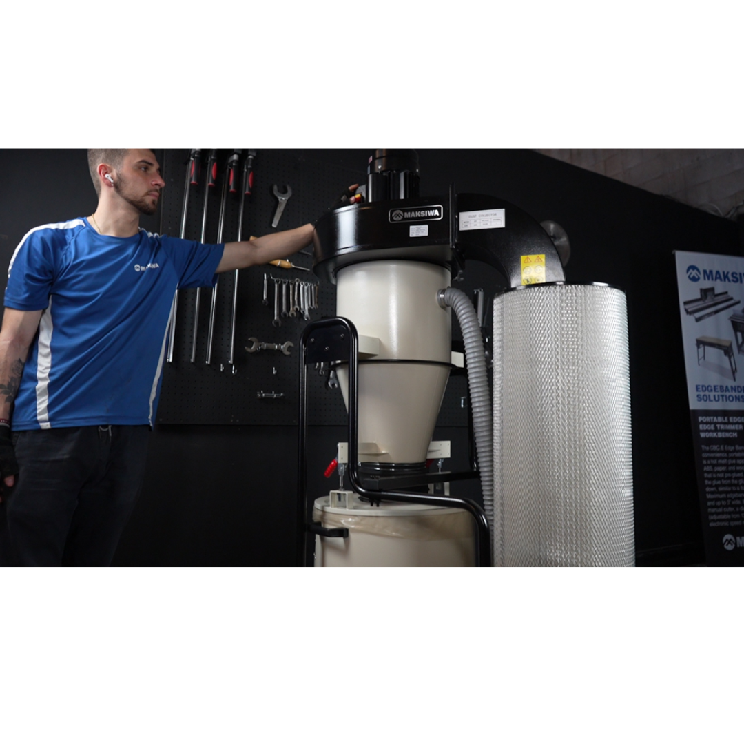 Technician standing next to Maksiwa CY/3.C cyclone dust collector for scale