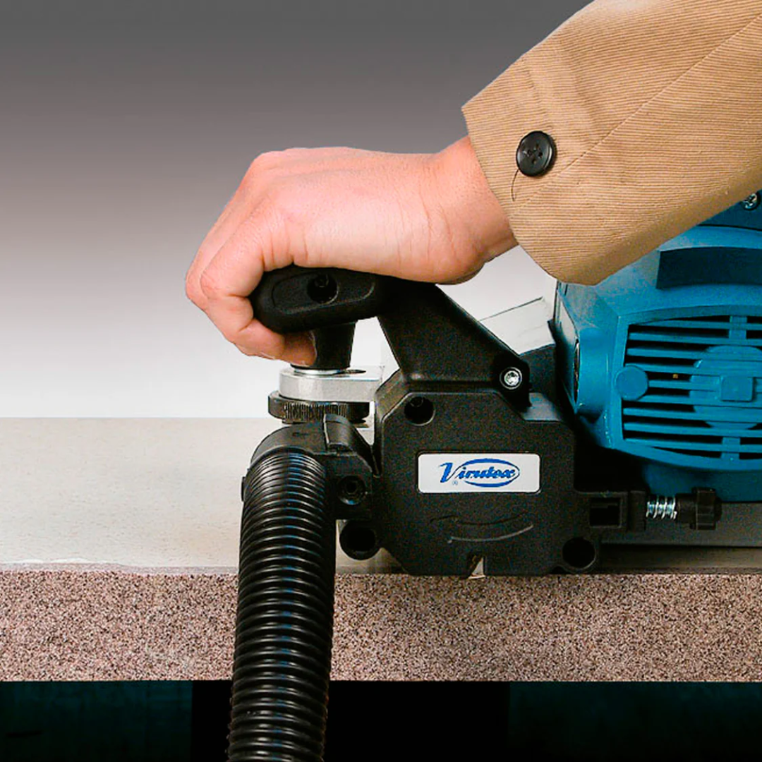 Virutex CE53S Edge Lipping Planer for Perfect Flush Edges 5300199 operator using planer with dust extraction hose for clean working environment