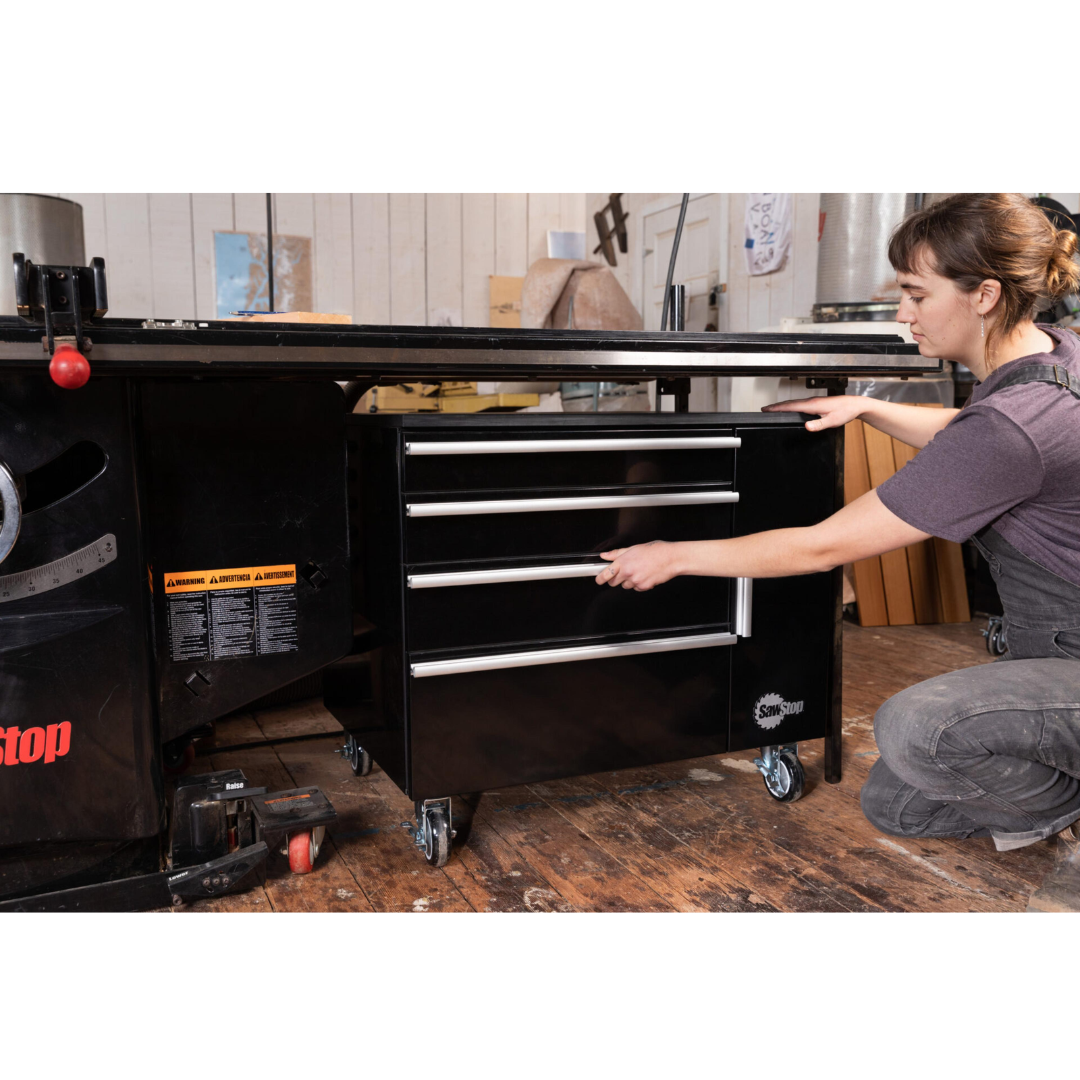 Woodworker accessing the SawStop Under Table Cabinet 32″ TSA-UTC32 during shop use, demonstrating convenient drawer organization and workflow optimization.