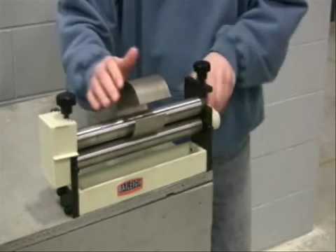 Baileigh Manual Slip Roll - (SR-1220M) 1007290 operator demonstrating manual sheet metal rolling capability for creating smooth curved profiles.
