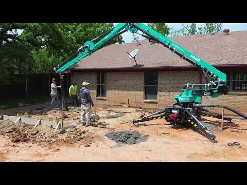 IMER GERRIS 800 Powered Crawler Concrete Placement Boom operating on residential construction site demonstrating remote-controlled concrete placement capabilities for foundation and slab work.