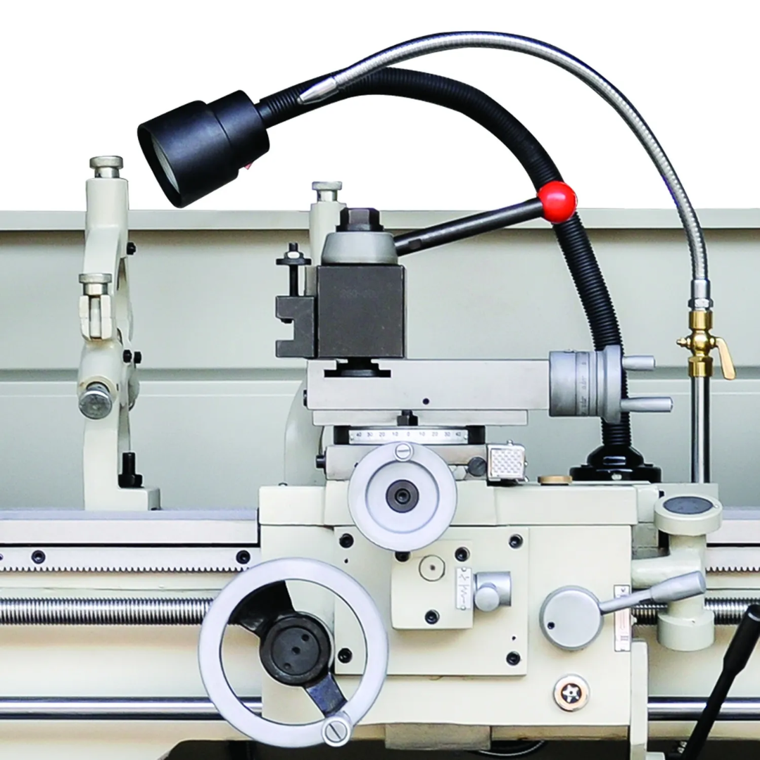 Angled view of the carriage, tool post, and coolant system on the Baileigh 12"x36" Geared Head Metal Lathe, X/Y-Axis DRO (PL-1236E-DRO) 1016617 demonstrating precision turning capabilities.