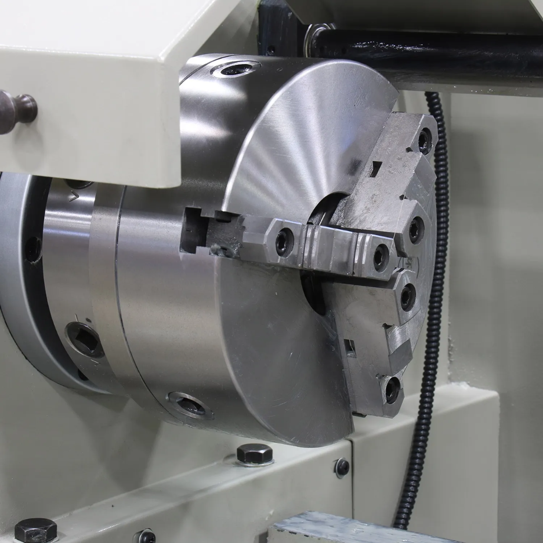 Baileigh Metal Lathe - PL-1860E 1016624 precision three-jaw chuck securely holding round workpieces for turning and facing applications.