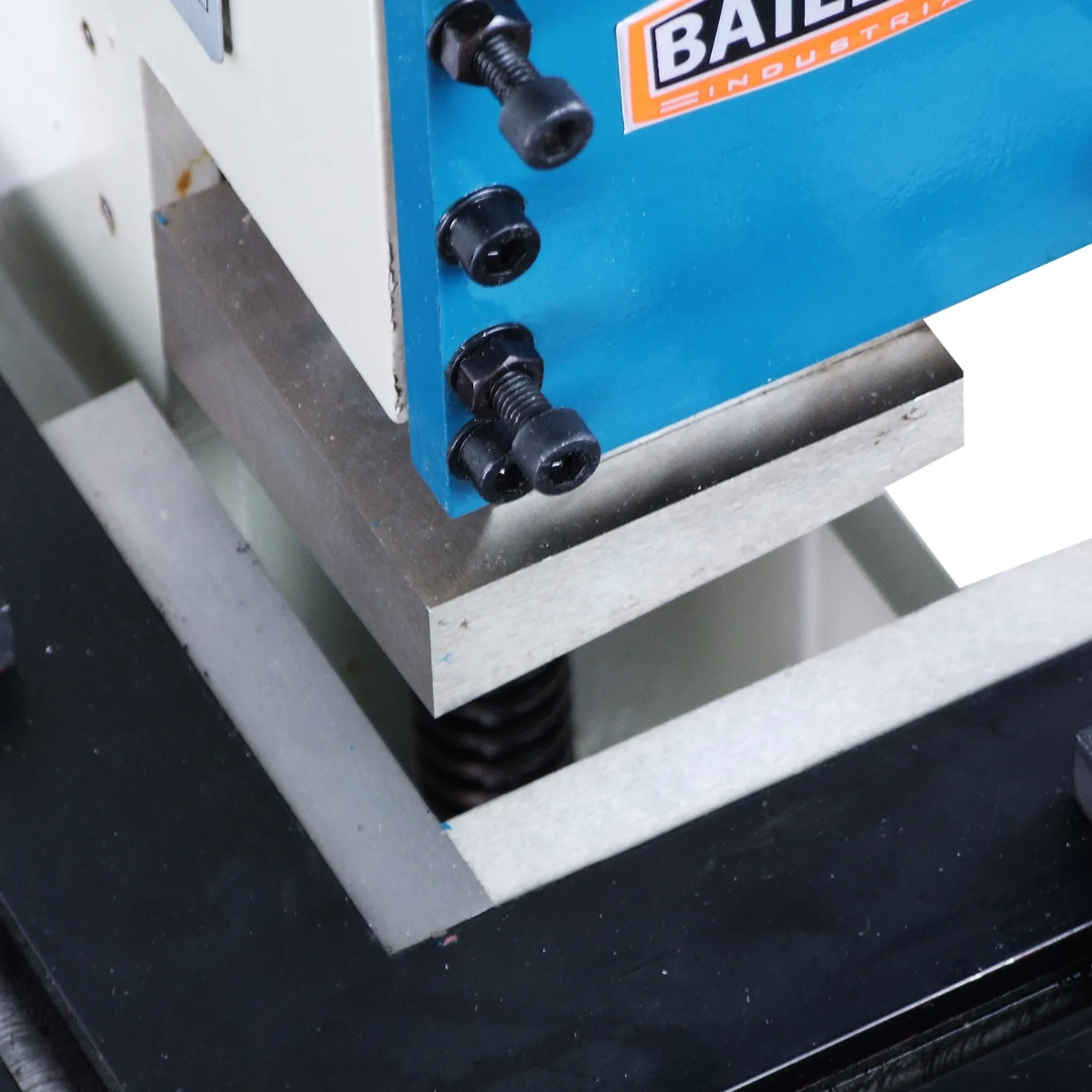 Baileigh Sheet Metal Corner Notcher SN-F16-FN 1007258 close-up of the hardened notching blades and precision-machined cutting table for accurate sheet metal corner notching.