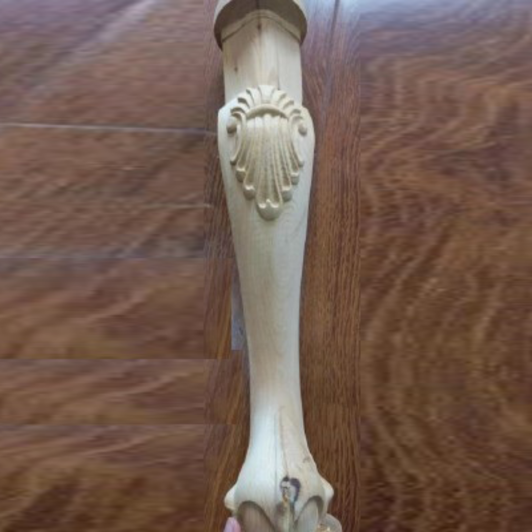 CNCCarvingMachine_RT-CAV_Example Decorative wooden handle with intricate carvings on a wooden surface