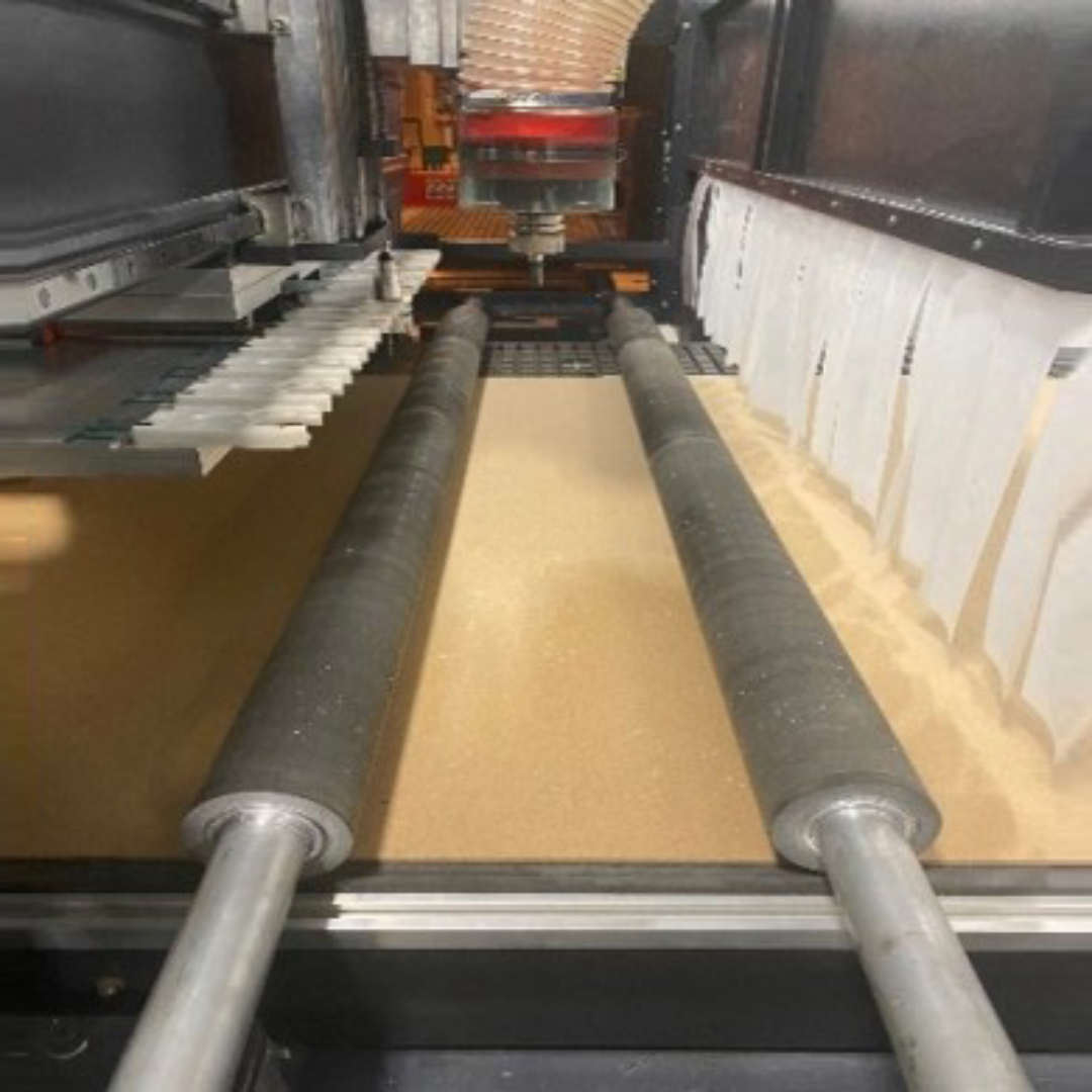 Castaly Rapid-12LN-RL CNC Router (With Press Roller & Enclosure Cover) press roller system feeding material across vacuum table during machining