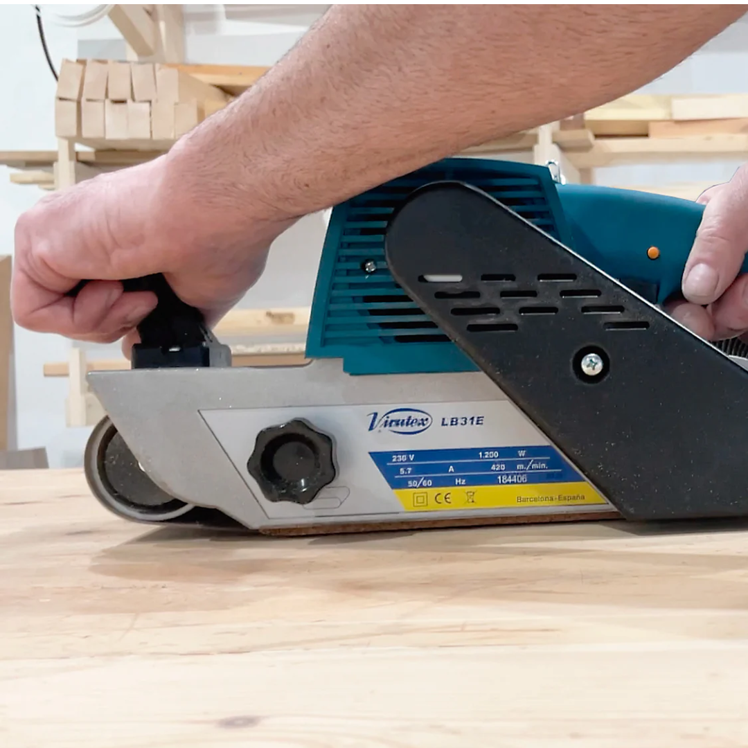 Close-up of Virutex Belt Sander LB31E Powerful Sanding Performance in use on wood surface for smooth and even material removal