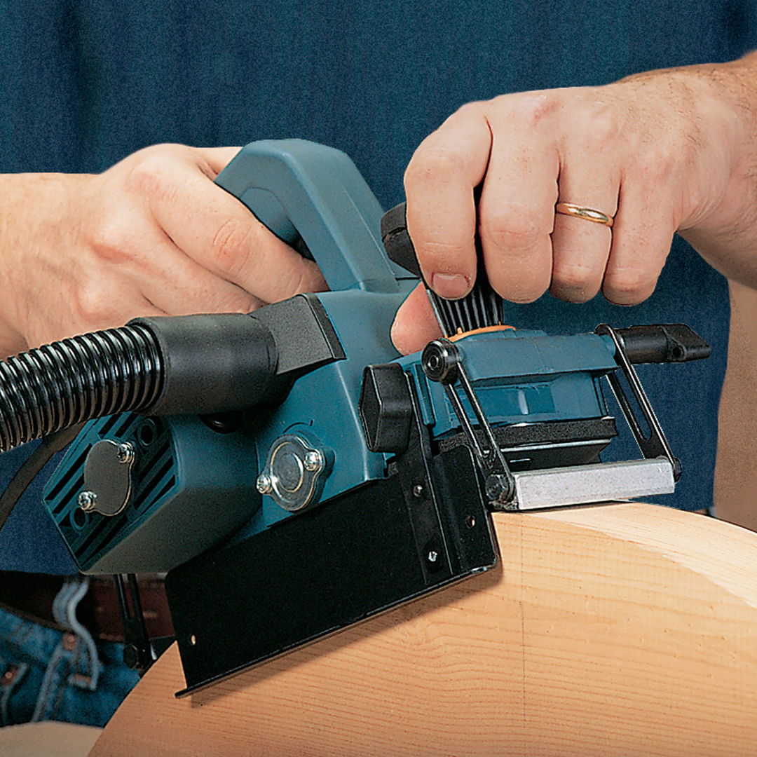 Close-up of Virutex CE96H Compass Planer For Curved Surfaces (120V) 9600099 showing precision control during curved edge shaping