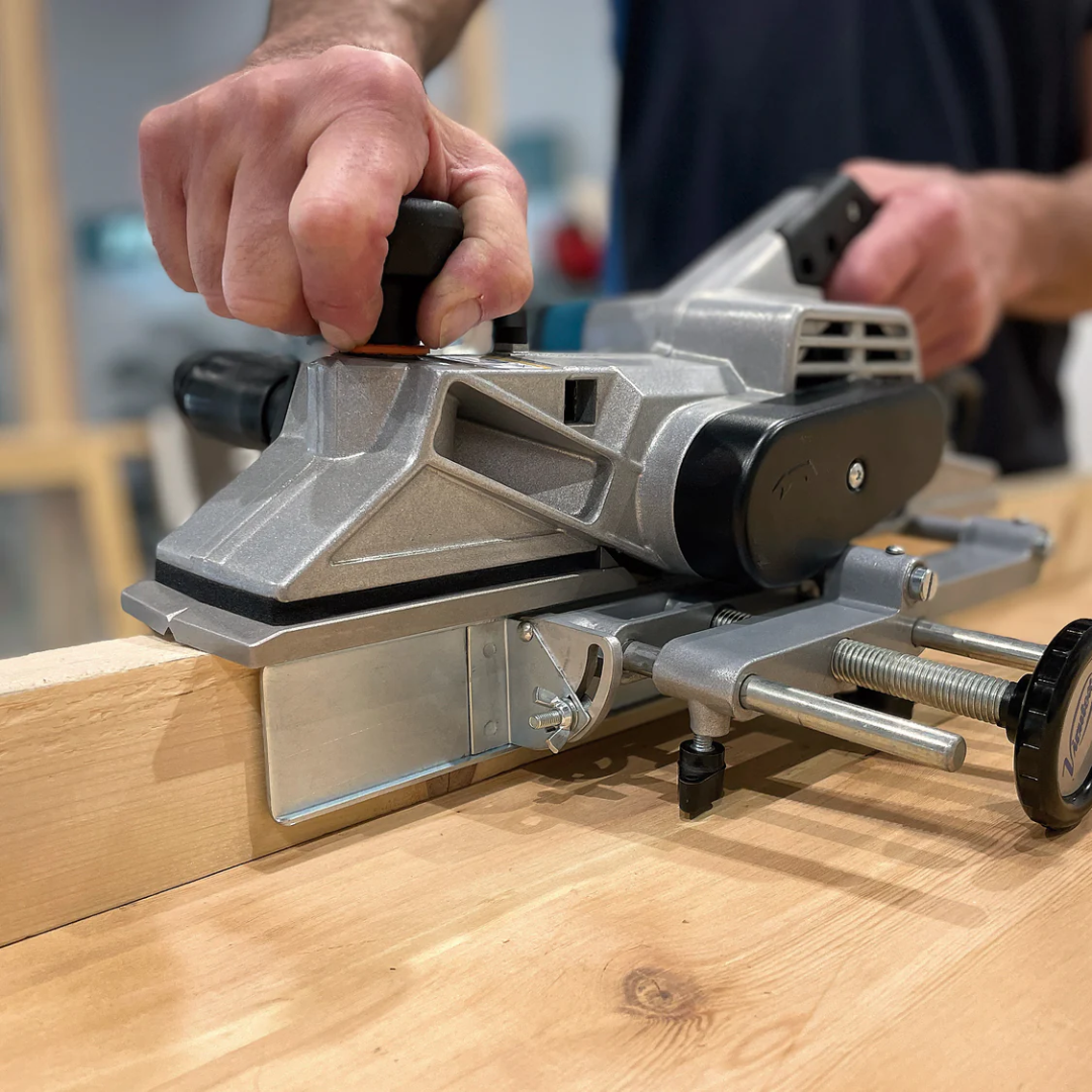 Close-up of Virutex Hand Planer CE24E For Fine Finishing (120V) 2400199 in operation highlighting powerful motor housing and precision blade alignment for professional woodworking.
