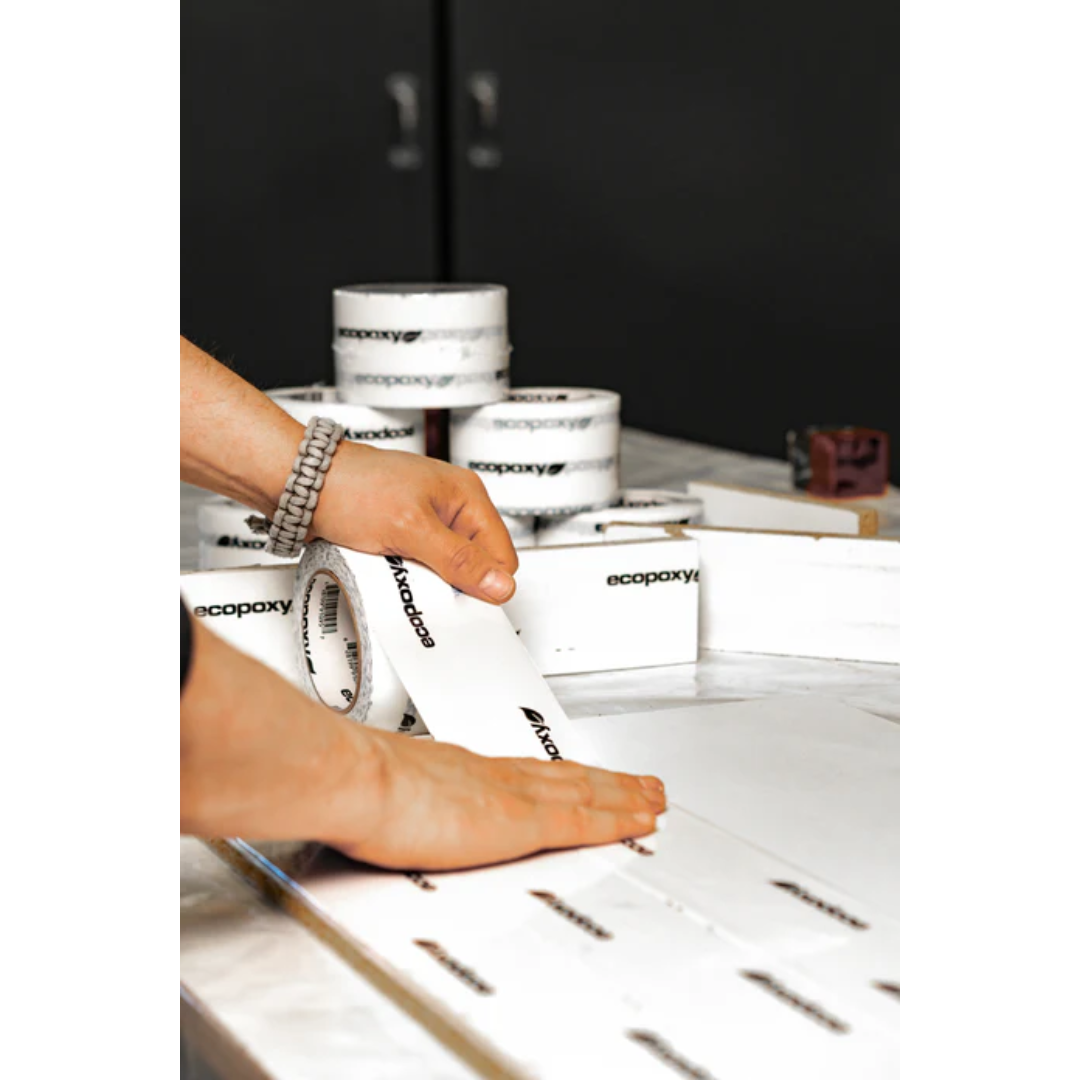 Close-up of epoxy mold preparation using Ecopoxy Epoxy Mold Release Tape EPMRT10-72X66-12PK in a woodworking workshop.
