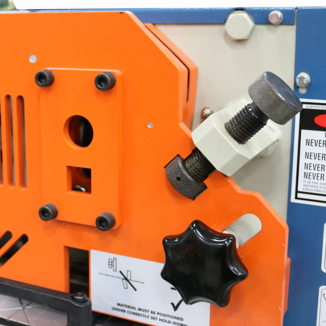 Close-up of the Baileigh 44-Ton 4-Station Hydraulic Ironworker, 220V 1Ph (SW-441) 1007756 showing the precision punch station with adjustable tooling for accurate hole punching in metal stock.