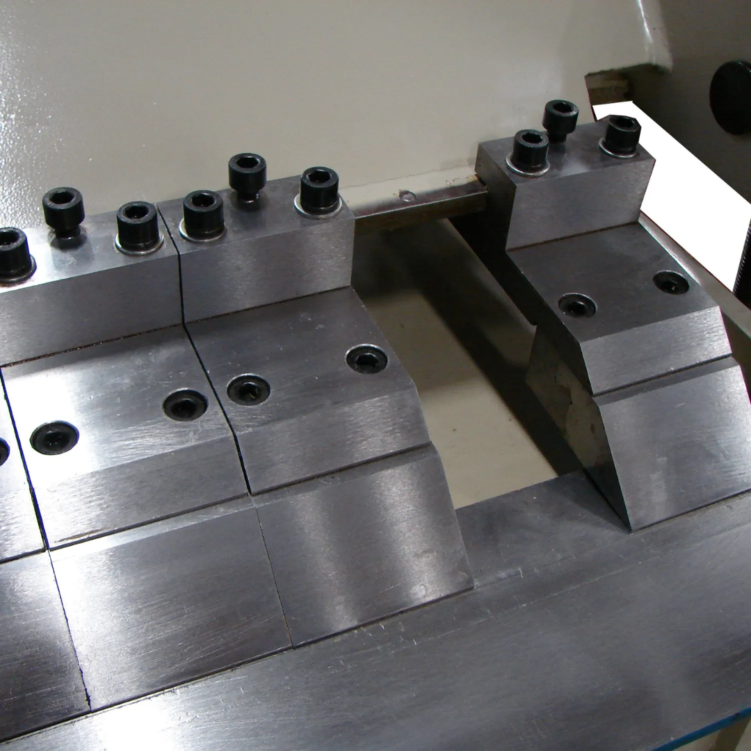 Close-up of the clamping and finger assembly on the Baileigh 48-Inch Box & Pan Brake, 14-Gauge Mild Steel (BB-4814) 1000417 highlighting precision-machined tooling and segmented finger design.