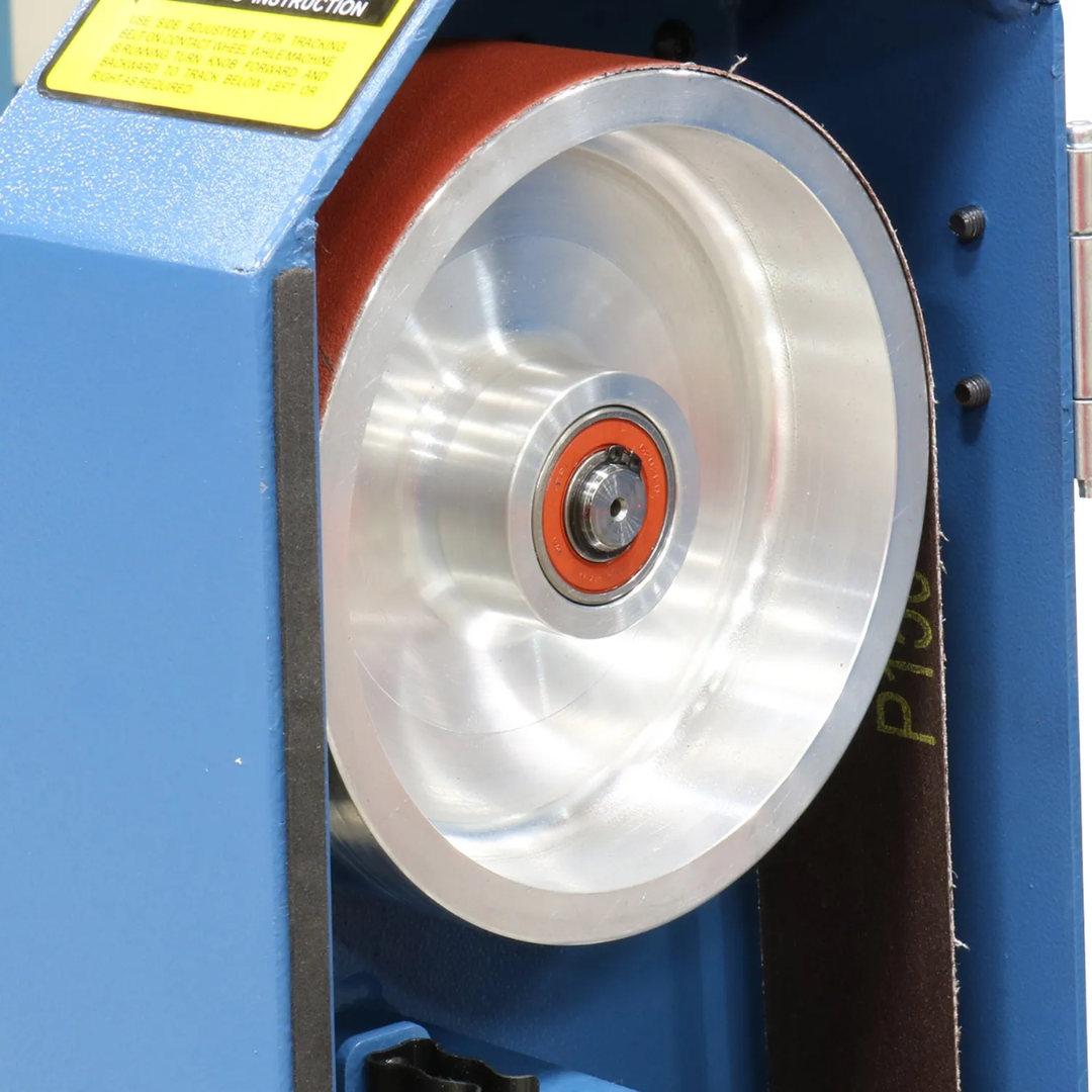 Close-up view of the Baileigh Two Wheel Belt Grinder BG-248-2 1019092 aluminum drive wheel assembly engineered for smooth belt tracking and consistent grinding performance.