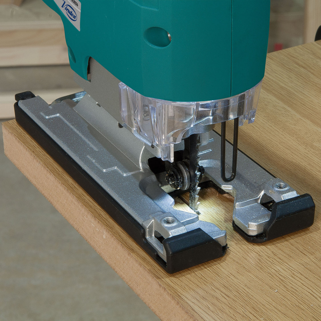 Detailed view of Virutex Cordless Jig Saw SCB324 performing precise curved cuts on wood surface