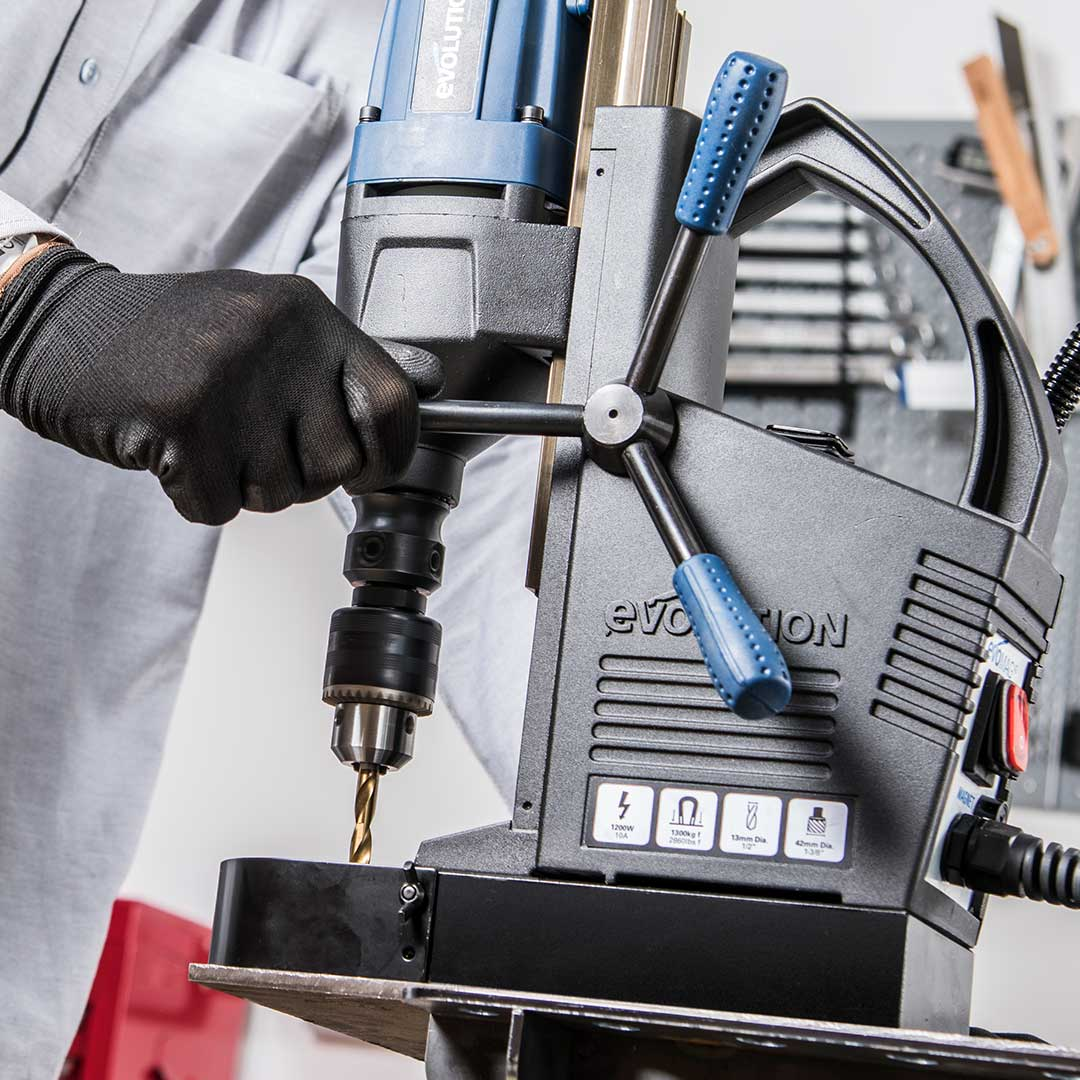 Evolution Power Tools 1-1/8 in. Magnetic Drill With Carry Case S28MAG mounted on a steel column, showcasing the powerful magnetic base and accurate vertical drilling capabilities for structural steel applications.