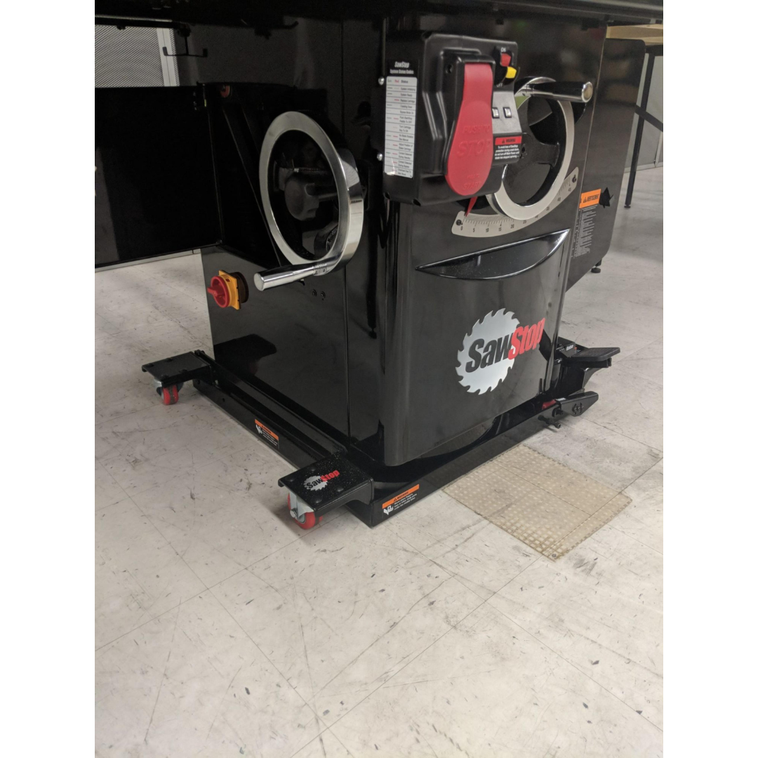Front-side view of the SawStop Industrial Saw Mobile Base MB-IND-000 mounted on a SawStop Industrial Cabinet Saw, showcasing the hydraulic foot-pedal mechanism and rugged steel construction.