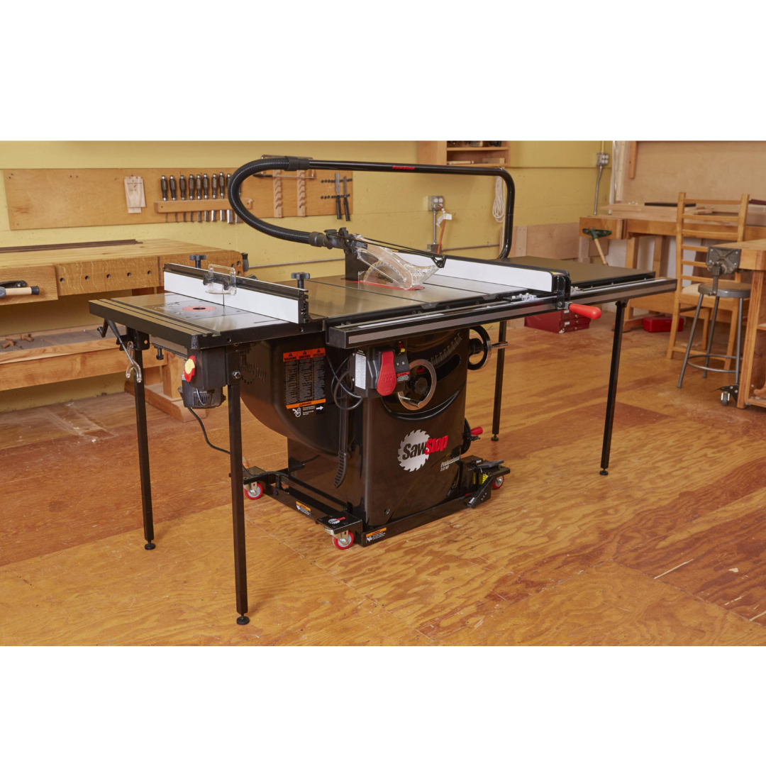 Full workshop view of the SawStop Professional Cabinet Saw featuring cast iron construction, large extension table, and professional fence assembly.