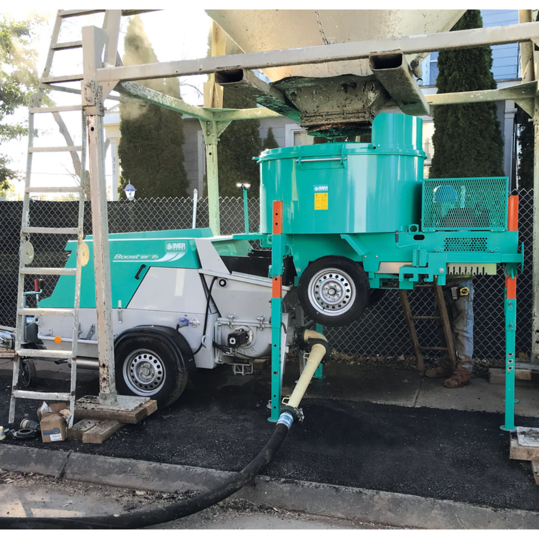 IMER BOOSTER 20 Piston Pump 1106427 active construction site operation demonstrating high-performance concrete, grout, and mortar pumping capabilities in demanding environments.