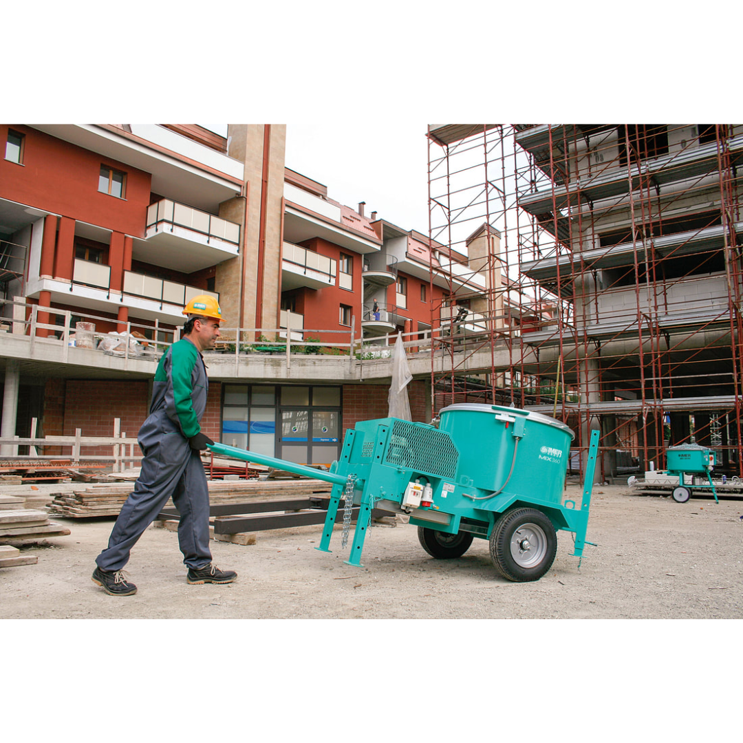 IMER MIX 360 Vertical Shaft Mixer operator loading material into reinforced mixing drum with integrated safety grate and dust control system