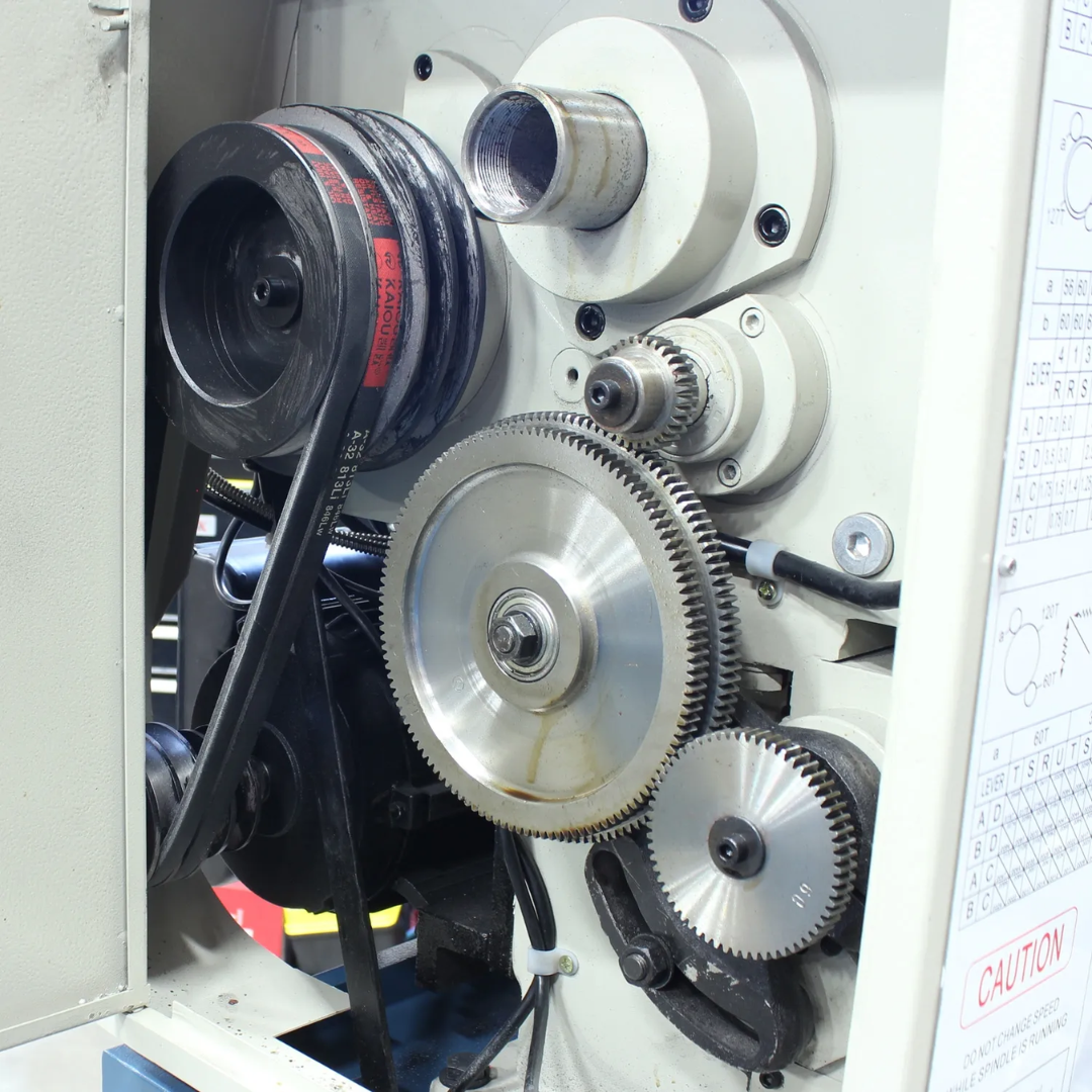 Internal geared drive mechanism of the Baileigh 12"x36" Geared Head Metal Lathe, X/Y-Axis DRO (PL-1236E-DRO) 1016617 showcasing durable power transmission components.