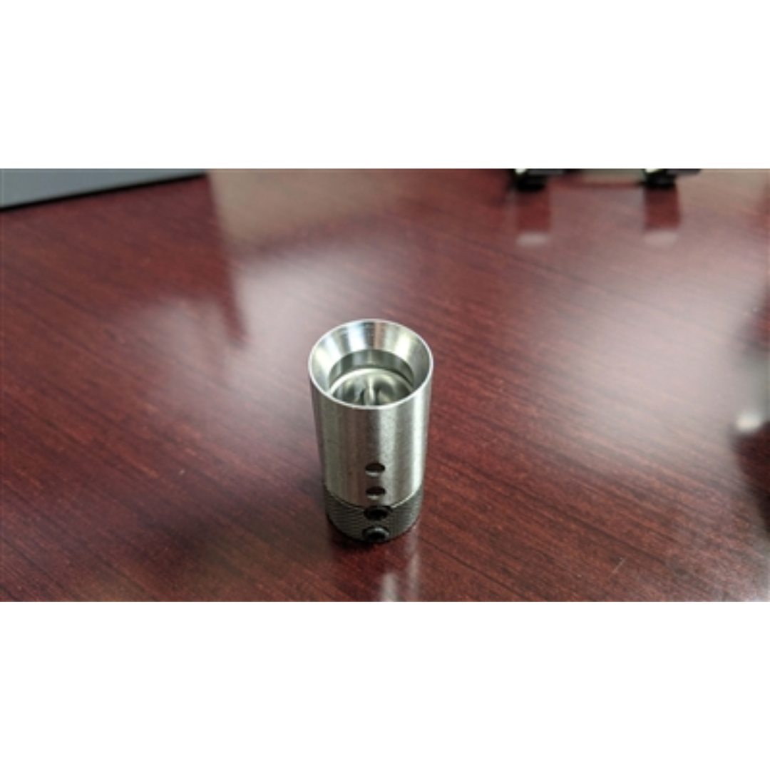 Maggi Quick Change Bit Adaptor 36000061 close-up view showing cylindrical steel body and quick-release mechanism on wooden surface