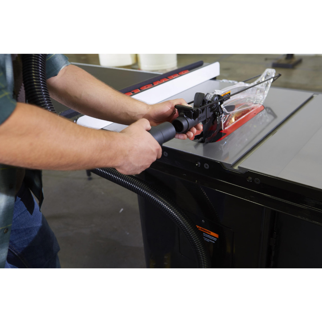 Operator adjusting the SawStop Overarm Dust Collection TSA-ODC blade guard assembly for improved dust collection and cutting visibility.