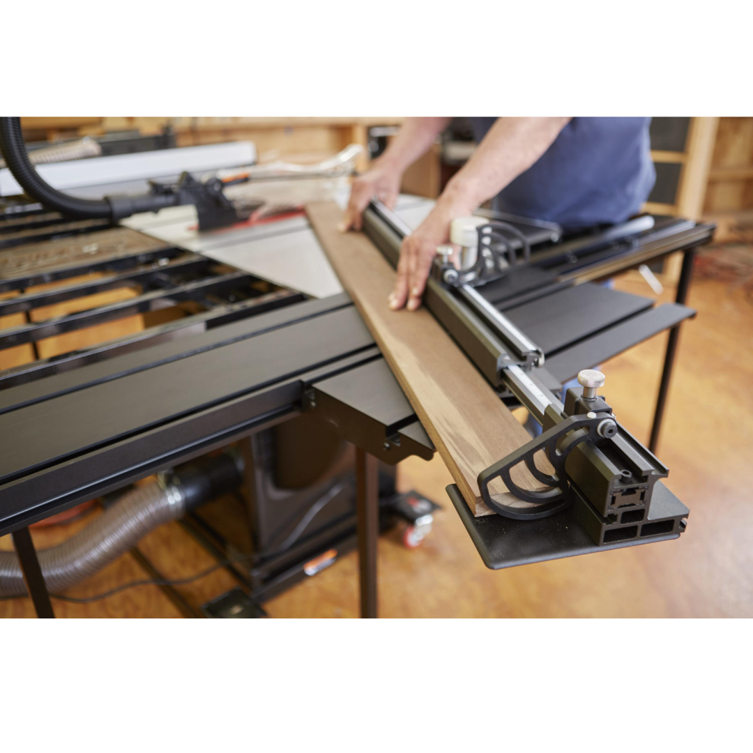 Operator adjusting the SawStop Sliding Crosscut Table TSA-SA48 fence system for accurate alignment and repeatable crosscut performance.