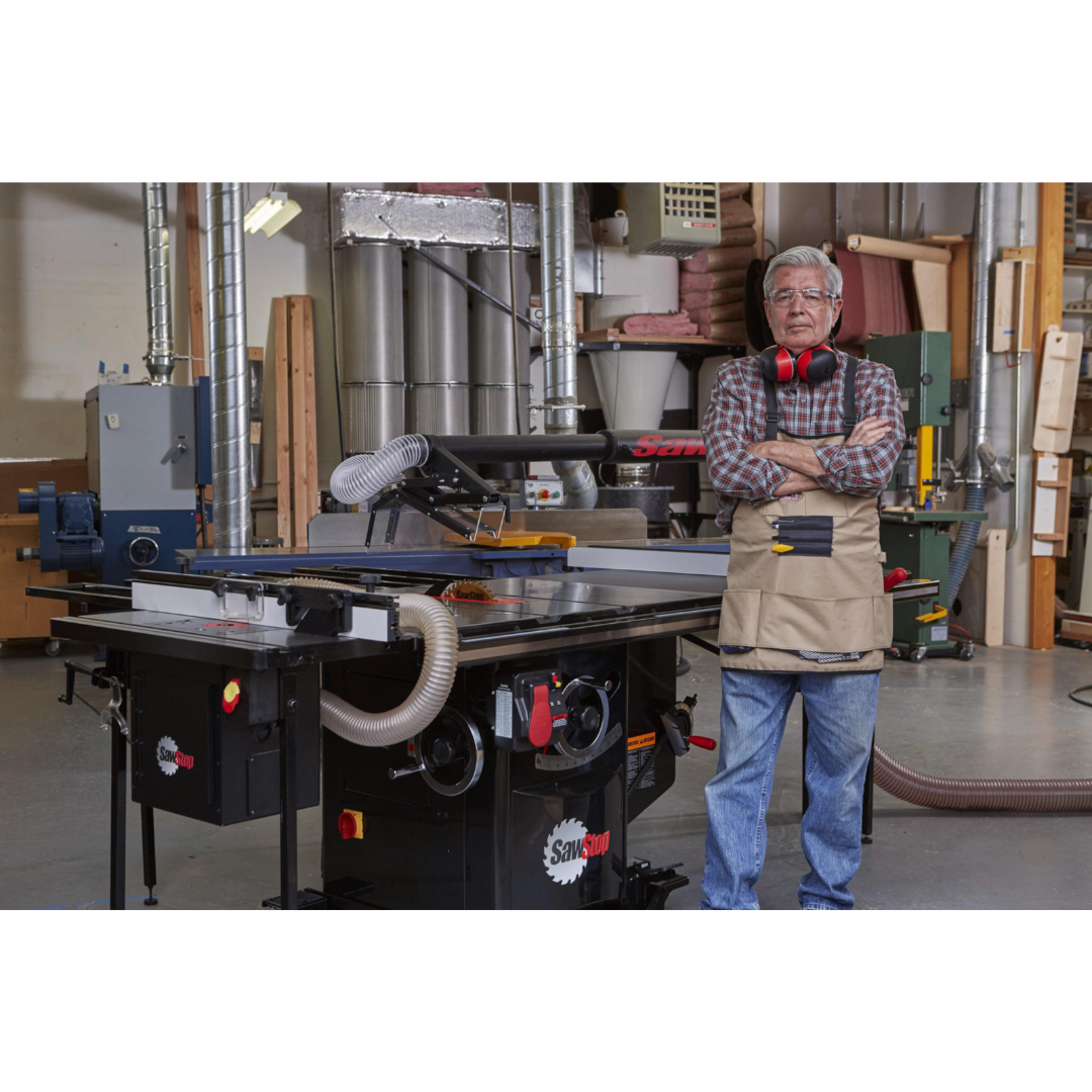 Operator standing beside the SawStop Industrial Cabinet Saw, showcasing full-size industrial cabinet saw construction and workshop integration.
