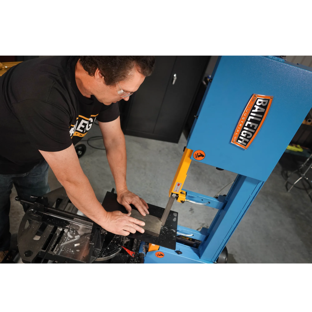 Operator using the Baileigh Portable EVS Dual Mitering Bandsaw BS-10VS 1232696 in a professional metal fabrication environment.