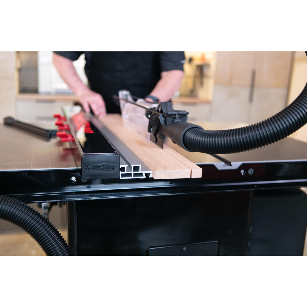 Operator using the SawStop T-Glide Advance Fence for precise ripping and repeatable woodworking cuts on a table saw.