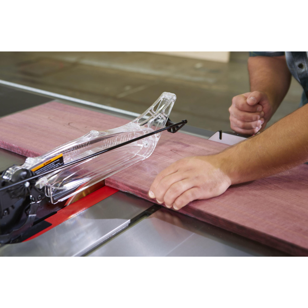 Precision ripping operation on the SawStop Professional Cabinet Saw with extended fence support and smooth material handling.