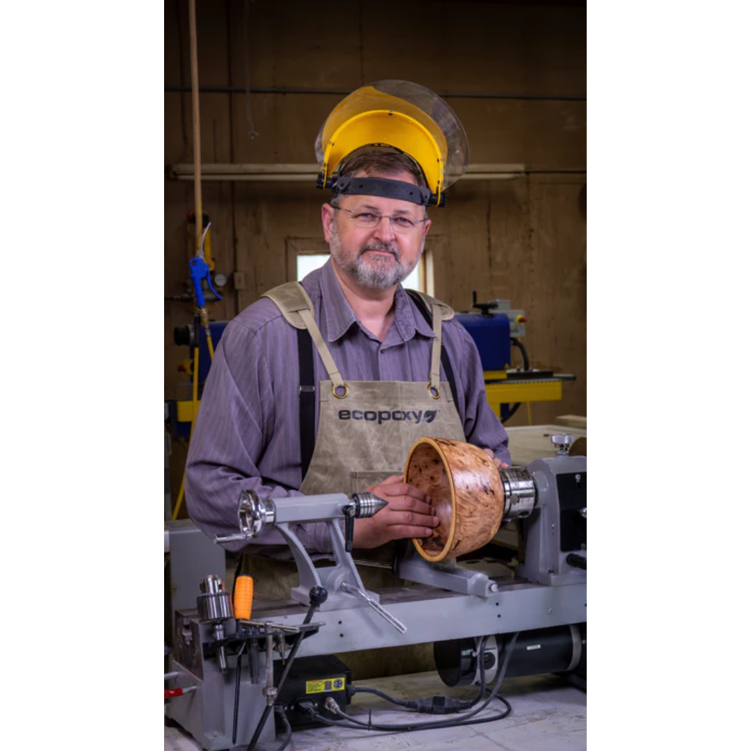 Professional craftsman wearing the Ecopoxy Canvas Apron EPAPR10-CV during woodworking and epoxy resin work.