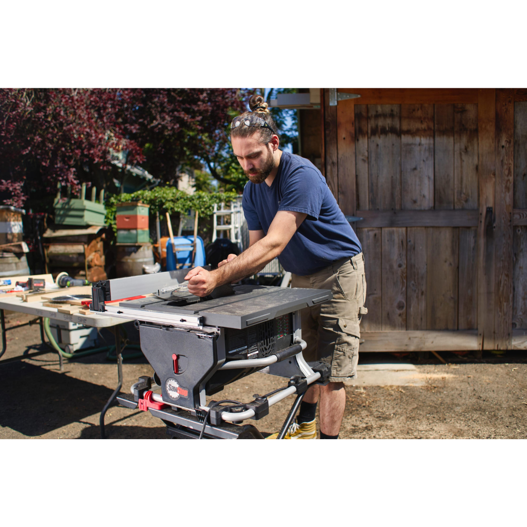 Professional woodworker using the SawStop Compact Table Saw in a workshop environment for precise cutting and enhanced safety.