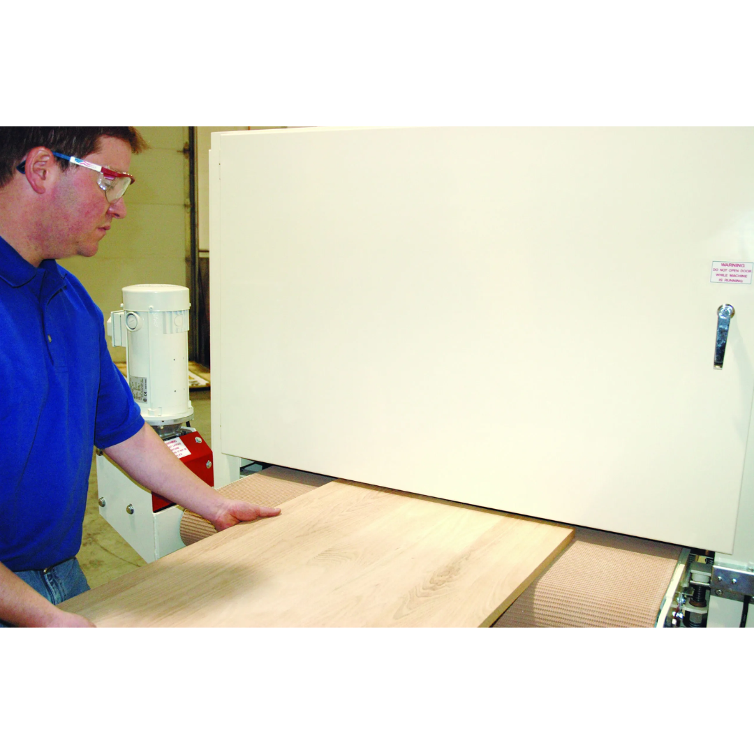 Safetyspeed 3760 Wide Belt Sander operator feeding material through machine for precision surface finishing