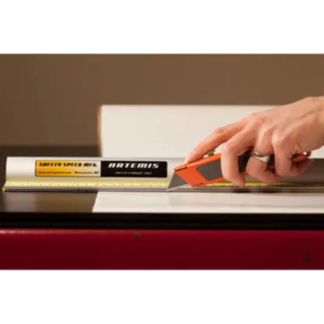 Safetyspeed Artemis Safety Straight Edge Ruler in use guiding a cutting tool along a straight line for precise and safe material trimming.