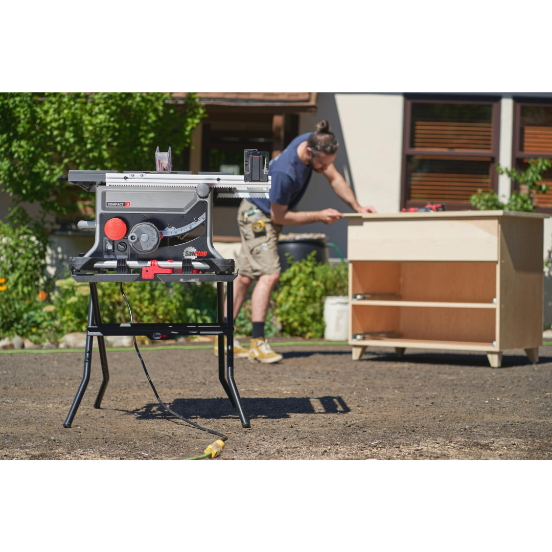 SawStop Compact Table Saw Folding Stand CTS-FS in use on a deck construction project, providing reliable support and quick deployment for portable woodworking and cutting tasks.