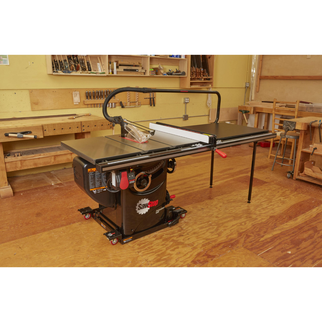 SawStop Industrial Mobile Base For PCS MB-PCS-IND installed on a SawStop Professional Cabinet Saw in a woodworking shop, demonstrating easy repositioning and stable equipment support.